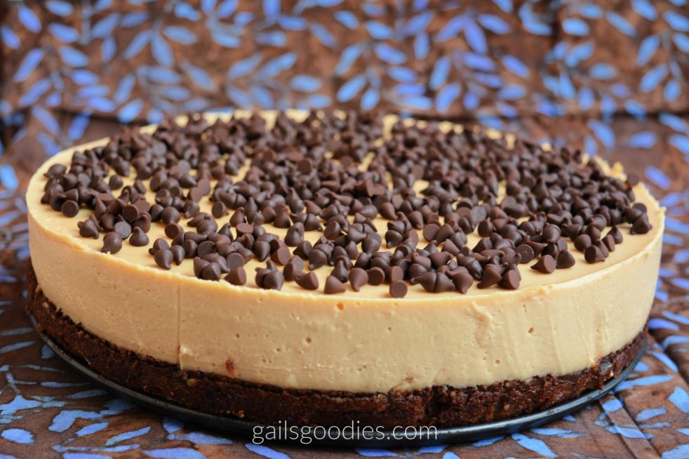 The bottom brownie layer on this cheesecake is about 1 inch thick. The creamy peanut butter cheesecake layer is about 2.5 inches thick. The top of the cheesecake is covered with mini-chocolate chips.